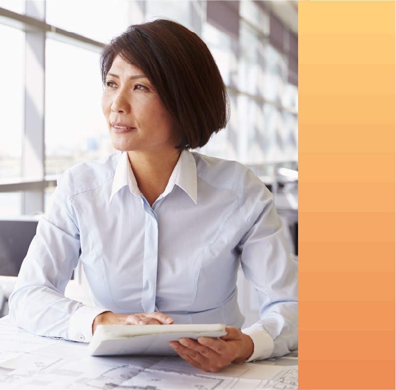 Woman works on a blueprint in an office